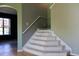 Carpeted stairs with white rails lead to the second floor at 369 James Cir, Lake Alfred, FL 33850
