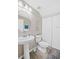 Clean bathroom featuring a pedestal sink, modern fixtures, and convenient storage space at 380 Carina Cir, Sanford, FL 32773