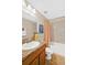 Bathroom featuring a vanity, toilet, shower, and decorative accents at 380 Carina Cir, Sanford, FL 32773
