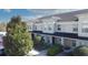 Two-story condo unit with neutral paint, dark roof, and manicured landscaping at 380 Carina Cir, Sanford, FL 32773