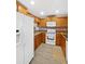 Well-maintained kitchen boasting wood cabinetry, modern appliances, and stylish tile flooring at 380 Carina Cir, Sanford, FL 32773