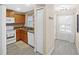 Efficient kitchen featuring wood cabinets, white appliances, and modern backsplash for easy meal prep at 380 Carina Cir, Sanford, FL 32773