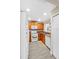Functional kitchen featuring wood cabinetry, white appliances, and easy access to storage at 380 Carina Cir, Sanford, FL 32773