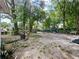 Spacious backyard filled with mature trees, providing a serene and private outdoor space at 4025 Luan Dr, Orlando, FL 32808