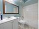 Bathroom with a white vanity, a large mirror, and a tiled shower-tub combination at 4025 Luan Dr, Orlando, FL 32808