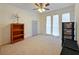 Spacious bedroom with neutral carpeting and three large windows providing ample light at 4025 Luan Dr, Orlando, FL 32808