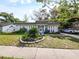 Charming single-story home with well-manicured landscaping and a classic facade with columns at 4025 Luan Dr, Orlando, FL 32808