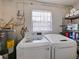 Convenient laundry room includes modern washer, dryer, water heater, and storage shelving at 4025 Luan Dr, Orlando, FL 32808