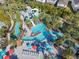 Magnificent aerial showcasing the pool area with the water slide, lazy river, and colorful umbrellas at 4098 Lana Ave, Davenport, FL 33897