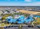 Aerial view of community pool area with a large pool and seating areas amidst lush landscaping at 4098 Lana Ave, Davenport, FL 33897