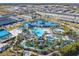 Expansive aerial view of the community pool, sports courts, and lush landscaping throughout the community at 4098 Lana Ave, Davenport, FL 33897