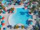 Aerial view of community pool featuring sun umbrellas and an abundance of lounge seating at 4098 Lana Ave, Davenport, FL 33897