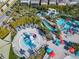 Stunning aerial shot of the community pool, splashpad, lazy river, putting green, and cabanas at 4098 Lana Ave, Davenport, FL 33897
