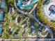 Drone image of the putting green and surrounding pool area with lazy river and splashpad at 4098 Lana Ave, Davenport, FL 33897