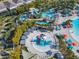 Gorgeous aerial view of the community pool, lazy river, splashpad, and surrounding landscaping at 4098 Lana Ave, Davenport, FL 33897