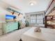 Bright bedroom with two beds, a bunk bed, television, surfboard, and colorful decor at 4098 Lana Ave, Davenport, FL 33897