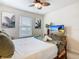 Bright bedroom with tropical accents, featuring a ceiling fan, a TV, and decorative artwork at 4098 Lana Ave, Davenport, FL 33897