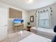 Bright bedroom featuring two beds, TV, mirror, and window with light-filtering blinds at 4098 Lana Ave, Davenport, FL 33897