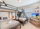 Bedroom features bunk beds, a double bed, and a flat-screen television for entertainment at 4098 Lana Ave, Davenport, FL 33897
