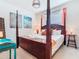 Bedroom boasts a four-poster bed, a TV, and unique decorations at 4098 Lana Ave, Davenport, FL 33897
