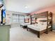 Bright bedroom featuring two beds, a bunk bed, television, and window with blinds at 4098 Lana Ave, Davenport, FL 33897