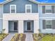 Charming townhome exterior featuring a two-tone facade, well-manicured landscaping, and inviting front entrances at 4098 Lana Ave, Davenport, FL 33897