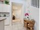 Hallway featuring stylish decor, leading to a bright entryway and a glimpse of the modern kitchen at 4098 Lana Ave, Davenport, FL 33897