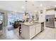Open-concept kitchen boasts a granite island, stainless steel appliances, and seamless flow to the living area at 4098 Lana Ave, Davenport, FL 33897