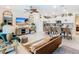 Inviting living room featuring an open floor plan with a kitchen island and a stylish entertainment center at 4098 Lana Ave, Davenport, FL 33897