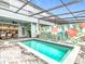 Inviting pool with colorful mural backdrop, plus a dining and seating area for outdoor enjoyment at 4098 Lana Ave, Davenport, FL 33897