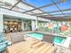 Charming enclosed pool and patio area with seating, dining, and a colorful mural at 4098 Lana Ave, Davenport, FL 33897