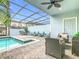 Enclosed pool area with sleek design, comfortable seating, and dining space, perfect for relaxation at 4098 Lana Ave, Davenport, FL 33897