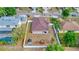 This aerial view showcases a home with a fenced yard, playground, shed, and mature landscaping in a suburban neighborhood at 427 Highland Meadows St, Davenport, FL 33837