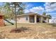 Back of house featuring a covered patio and wooden playset in the yard at 427 Highland Meadows St, Davenport, FL 33837