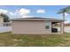 Backyard showcasing a covered patio, grill, and fenced yard at 427 Highland Meadows St, Davenport, FL 33837