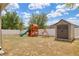 Backyard featuring a wooden playset, swing set, and storage shed at 427 Highland Meadows St, Davenport, FL 33837