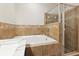 Bathroom showcasing a glass shower enclosure, bathtub, and decorative tilework at 427 Highland Meadows St, Davenport, FL 33837