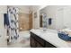 Bathroom featuring dark cabinets, white countertop, patterned shower curtain, and a sink at 427 Highland Meadows St, Davenport, FL 33837