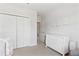 Bedroom featuring a white dresser, closet, and door at 427 Highland Meadows St, Davenport, FL 33837