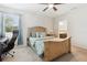 Inviting bedroom with a large bed, neutral walls, a ceiling fan, and adjacent office/study space for remote work at 427 Highland Meadows St, Davenport, FL 33837