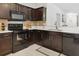 Kitchen featuring dark cabinetry, stainless steel appliances, bright counter tops, and a decorative tile backsplash at 427 Highland Meadows St, Davenport, FL 33837