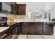 A contemporary kitchen with sleek, dark cabinetry, modern appliances, and stylish countertops and tile backsplash at 427 Highland Meadows St, Davenport, FL 33837