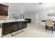 An open concept kitchen with stainless steel appliances, bright counter tops, and sight lines to the living and dining area at 427 Highland Meadows St, Davenport, FL 33837