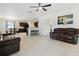 Open-concept living room with tile flooring, a ceiling fan, and contemporary furniture at 427 Highland Meadows St, Davenport, FL 33837