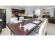 Open concept kitchen and living room includes stainless appliances, a fireplace, and leather seating at 427 Highland Meadows St, Davenport, FL 33837
