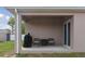 Covered patio area featuring a grill, chairs, and small table at 427 Highland Meadows St, Davenport, FL 33837