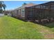 Spacious backyard with green lawn and screened patio at 450 Morning Blossom Ln, Oviedo, FL 32765