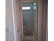 Compact bathroom with a shower behind glass doors, toilet, and floor mat at 450 Morning Blossom Ln, Oviedo, FL 32765