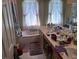 Bright bathroom featuring a tub, vanity with dual sinks, and ample counter space at 450 Morning Blossom Ln, Oviedo, FL 32765