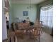 Bright dining room with natural light, glass-top table, and chandelier at 450 Morning Blossom Ln, Oviedo, FL 32765